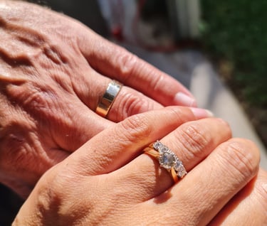 Image of Danny and Lana Weller, holding hands showing wedding rings, after their wedding, Brisbane