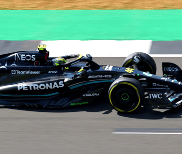 a racing car with a driver and background blur