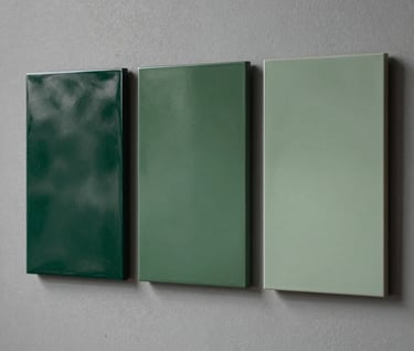 Photography of three square resin art panels from Series IV displayed in a row on a Soft Stone Grey wall, showing a gradient of Deep Forest Green to Muted Sage tones.