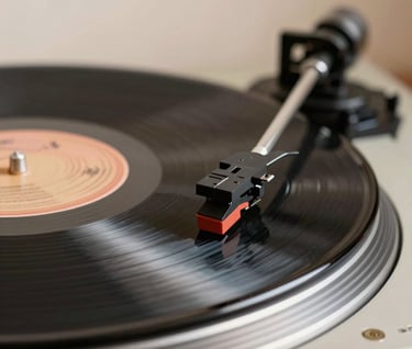 An atmospheric, close-up shot of a vinyl record playing on a turntable. The focus is sharp on the stylus touching the charcoal-colored grooves. The background is a soft blur of cream and tan, creating a professional and inviting aesthetic. International / Western style.