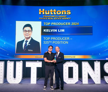 Huttons Real Estate Top Producer Kelvin Lim receiving an award on stage in Singapore.