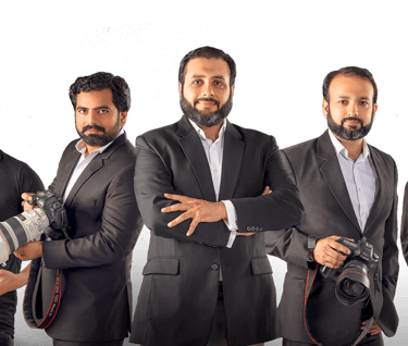 a group of people standing around a camera