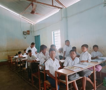 a group of children sitting at desks in a classroom