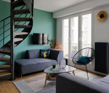 a living room with a spiral staircase and a couch