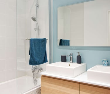 a bathroom with a blue wall and a white sink