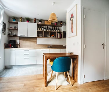 a kitchen with a table and chairs in the middle of the room