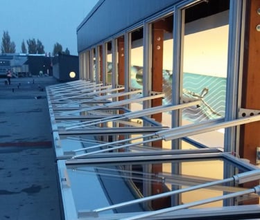 a row of windows with a view of a beach