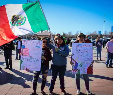 a group of people holding up signs at an event with Organizing Okies