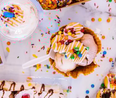 a table with desserts and sweets ice cream, cookies and smarties