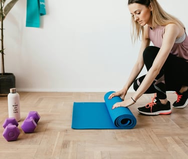 a woman is sitting on a yoga mat with a blue yoga mat