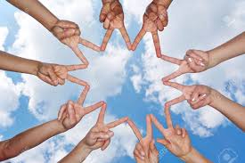 a group of people holding hands up in the air