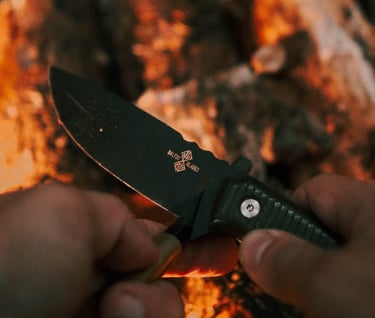 a person holding a knife and a knife in their hand varnas baltic blades