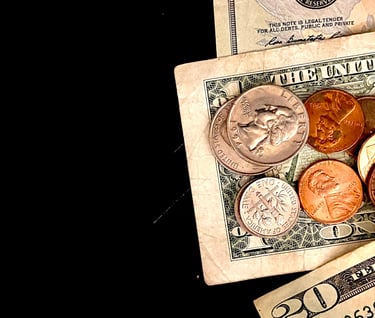 a pile of coins and a dollar bill