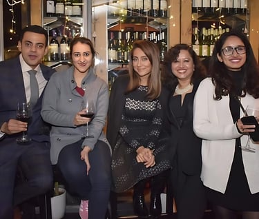 a group of people standing around a bar