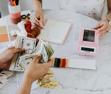 investing and longevity - a woman is holding money and a cell phone