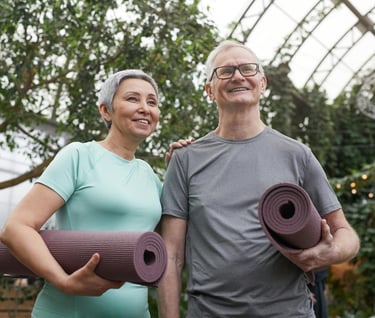 Relationships and Longevity - a man and woman holding yoga mats in a greenhouse