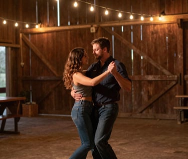 A cinematic medium shot of a couple dancing in an open North American barn. The lighting is warm from strings of bulbs, casting deep brown and charcoal shadows, capturing a genuine, unposed moment of connection.