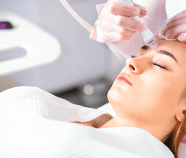 Professional esthetician performing a microneedling skin treatment at Skin Therapy Solutions
