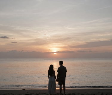 A serene shot of a couple standing on a black sand beach in Bali as the sun sets. The water reflects the warm, muted tones of the sky. Palette: #3F322A and #F8F5EF.