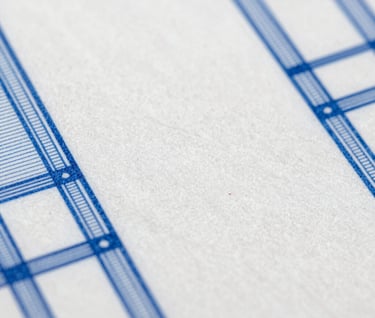 Macro photography of white paper textures and architectural blueprints with cerulean blue ink lines, minimalist Bauhaus style.