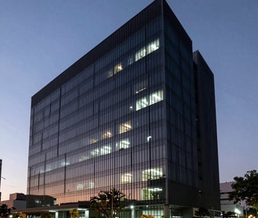 Atmospheric wide shot of a modern, dark Brazilian office building exterior at dusk. Minimalist architecture with sharp white lights and a hint of dark green shadows.
