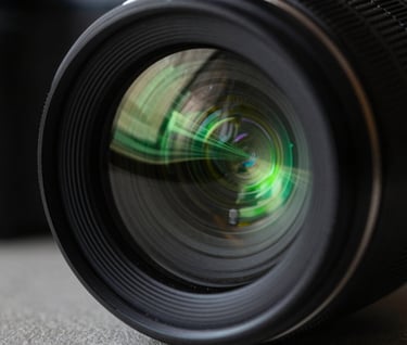 Abstract macro photography of a glass camera lens reflecting complex digital motion graphics. The palette is dominated by deep black and vibrant neon green. High-tech, minimalist aesthetic.