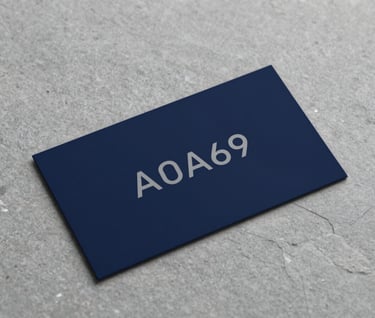 Luxury business card mockup placed on a textured stone surface. The design is minimalist, featuring a logo in #A0A696 on a #0F1E2E background. High-end, strategic aesthetic.