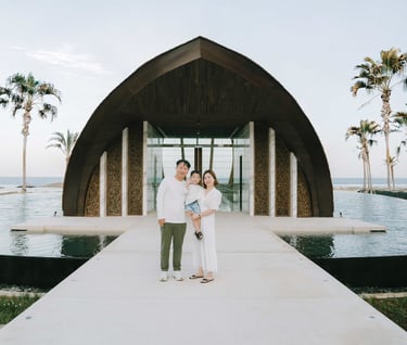 Family portrait in front of the iconic chapel architecture at The Apurva Kempinski Bali.
