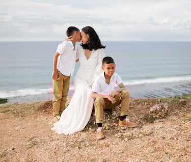 Ayunda family portrait standing on the cliff at Melasti Beach Bali during a relaxed family photography session.