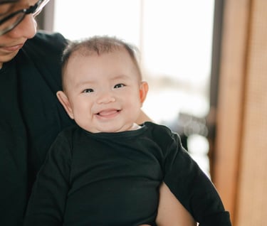Parents playing with baby during a family photography session at a private villa in Ubud Bali.