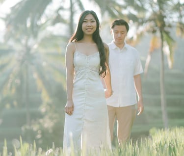 Couple walking through the rice field during a sunrise photography session at Tegalalang Ubud Bali.