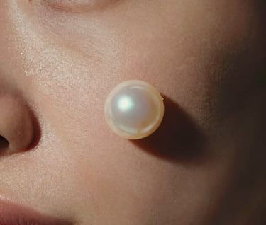 Cinematic close-up of human skin reacting to sound-induced vibrations, captured under soft milky pearl lighting with deep charcoal shadows.