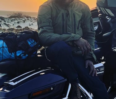 a man sitting on a motorcycle with a motorcycle