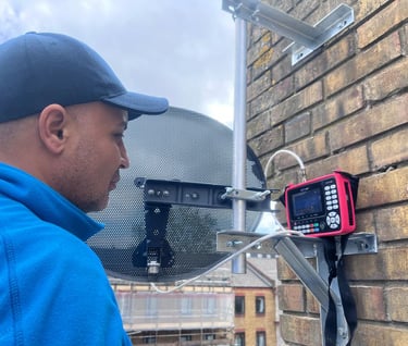 Man installing sky dish and antenna in one tube bar