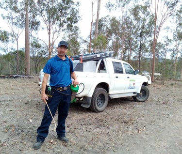 pest control technician standing in front of pest vehicle