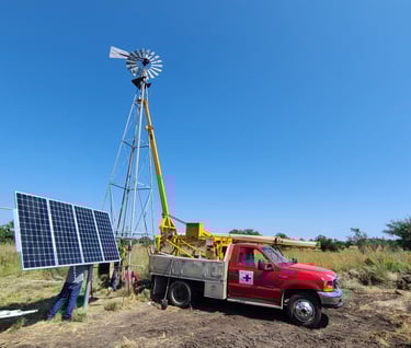 a truck, a windmill, and a solar panel