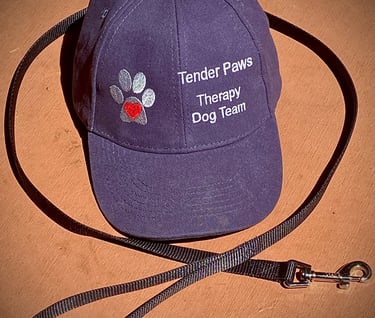 A Tender Paws Therapy Dog Team baseball cap and a dog leash