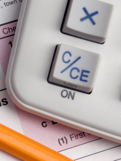 a calculator and pencils on a desk