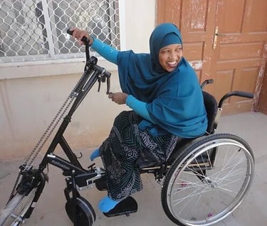 Somali woman in wheelchair, representing inclusivity and empowerment for disabled individuals in Somalia and beyond.