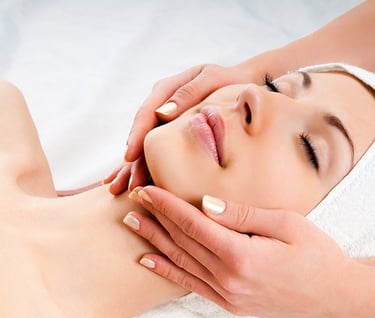 a woman getting a facial massage at a spa
