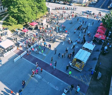 an overhead drone photo of the starting line and vendor expo at the chick fil a 10K in athens, AL