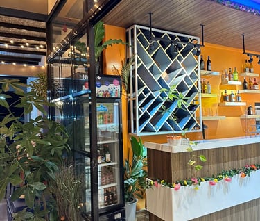 a bar with a wine rack and a stock of alcoholic beverages