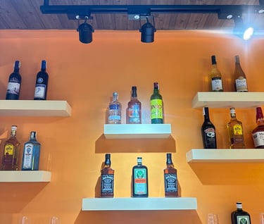 stock of alcoholic drinks displayed at the bar of Ameia