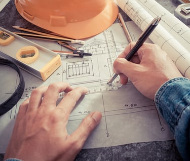 a person is holding a pen and writing on a paper