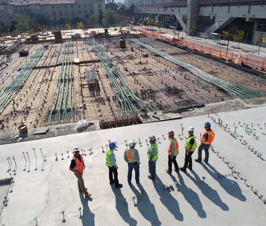 a group of construction workers standing on a roof top
