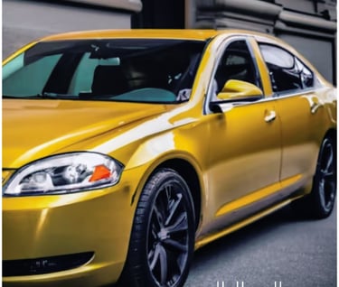 a yellow Chevrolet Impala parked on the side of a street