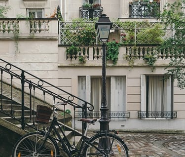 a bicycle parked next to a staircase with a lamp post