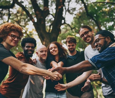 a group of people holding hands in a circle