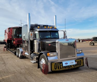 a semi truck with a large trailer parked in a lot