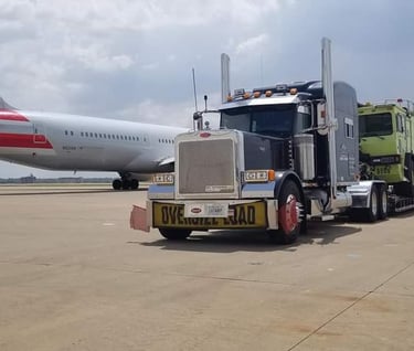 a truck with a large trailer parked on the tarmac